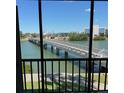 Balcony view showcases the scenic bridge over the water and nearby building complexes in the distance at 7465 Bay Island S Dr # 211, South Pasadena, FL 33707