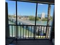 Scenic balcony view features a bridge over the tranquil waters, connecting to the buildings across the waterway at 7465 Bay Island S Dr # 211, South Pasadena, FL 33707