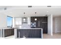 Contemporary kitchen featuring stone countertops, stainless appliances, and stylish pendant lighting at 777 3Rd N Ave # 1308, St Petersburg, FL 33701
