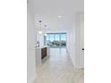 Bright living room and kitchen area with city views through sliding glass doors and modern pendant lighting at 777 3Rd N Ave # 707, St Petersburg, FL 33701