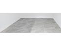New construction condo features grey stone-look tile flooring and white baseboards at 777 3Rd N Ave # 707, St Petersburg, FL 33701
