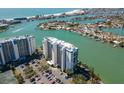 Waterfront condominiums boast stunning coastal views and convenient parking in this clear aerial shot at 9495 Blind Pass Rd # 308, St Pete Beach, FL 33706