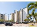 The condo building features multiple floors, ample parking, and a modern design at 9495 Blind Pass Rd # 308, St Pete Beach, FL 33706