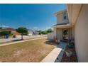 Inviting home exterior highlighting the walkway and front yard with well-kept landscaping and green grass at 10645 Laguna Plains Dr, Riverview, FL 33578