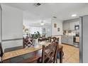 Cozy dining area featuring wood table and seating, open to living area and kitchen at 111 Inwood Cir, Brandon, FL 33510