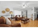 Inviting living room featuring hardwood floors, neutral decor, and comfortable seating at 111 Inwood Cir, Brandon, FL 33510