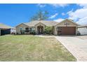 Inviting single-story home showcasing a manicured lawn and stylish two-car garage, perfect for comfortable living at 13416 Algoma Ave, Spring Hill, FL 34609