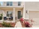 Inviting front porch with chairs and beautiful landscaping and tasteful stone accents at 16709 Barnwood Pl, Bradenton, FL 34211