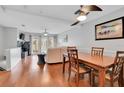 Open-plan living and dining area with hardwood floors, fireplace, and plenty of natural light at 17960 Gulf Blvd # 104, Redington Shores, FL 33708
