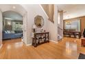Inviting foyer with hardwood floors, console table with decor, and staircase leading to the upper level at 19139 Cypress Reach Ln, Tampa, FL 33647