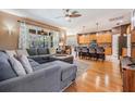 Spacious living room that opens to the kitchen featuring hardwood floors and an oversized sectional sofa at 19139 Cypress Reach Ln, Tampa, FL 33647