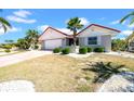 Charming single-story home with a red tile roof, two-car garage, and desert landscaping at 1969 Wolf Laurel Dr, Sun City Center, FL 33573