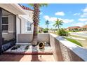 Charming front porch with decorative landscaping and a view of the peaceful neighborhood street at 1969 Wolf Laurel Dr, Sun City Center, FL 33573