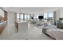 Open-concept living room with a large island, modern lighting, and floor-to-ceiling windows with a view at 2103 Bayshore Blvd # 1701, Tampa, FL 33606
