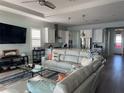 Bright and airy living room flowing into a modern kitchen with white cabinets and stainless steel appliances at 2217 5Th E St, Palmetto, FL 34221
