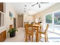 Dining area with a pool view through sliding doors, wood table, and modern light fixture at 3302 W Caracas St, Tampa, FL 33614