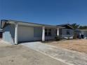 Exterior view of a charming blue home with a well-maintained lawn and inviting curb appeal at 3309 Rock Royal Dr, Holiday, FL 34691