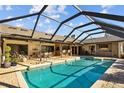 Enjoy this spacious pool area with ample seating and shade for outdoor entertaining at 3579 Landmark Trl, Palm Harbor, FL 34684