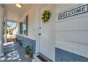 Inviting front entrance featuring a charming 'Welcome' sign and decorative wreath at 3624 Hendrix St, New Port Richey, FL 34652