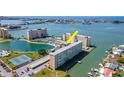 Beautiful aerial view of waterfront condominium featuring tennis courts and boat docks at 4725 Cove Cir # 810, St Petersburg, FL 33708