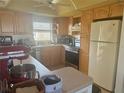 Light and bright kitchen with stainless steel appliances and honey colored cabinets at 4725 Cove Cir # 810, St Petersburg, FL 33708