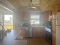 Bright eat-in kitchen features honey colored cabinets and a stunning water view at 4725 Cove Cir # 810, St Petersburg, FL 33708