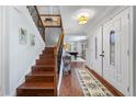 Inviting entryway featuring wood floors, staircase, and a decorative rug leading to the game room at 4912 W Bay Way Dr, Tampa, FL 33629