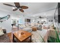 Open-concept living room featuring a large sectional couch, hardwood floors, and a wet bar at 4912 W Bay Way Dr, Tampa, FL 33629