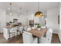 Kitchen and dining room featuring white cabinets, granite countertops and stainless steel appliances at 5530 N 9Th St # 1, Tampa, FL 33604