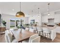 Open concept floorplan with kitchen island with counter seating and view to the living room at 5530 N 9Th St # 1, Tampa, FL 33604