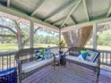 Relax on the porch with views of the front yard while enjoying the beautiful scenery at 5870 Jim Davis Rd, Parrish, FL 34219