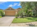 Charming single-Gathering home with manicured lawn and beautiful landscaping at 6130 Whimbrelwood Dr, Lithia, FL 33547