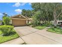 Charming home featuring well-maintained lawn, landscaping and spacious driveway at 6130 Whimbrelwood Dr, Lithia, FL 33547