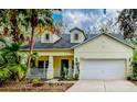 Inviting single-Gathering home with a cozy porch, neat landscaping, and a convenient two-car garage at 6230 Gannetdale Dr, Lithia, FL 33547