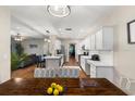 Open kitchen, seamlessly connected to living area, featuring white cabinets and stainless appliances at 6230 Gannetdale Dr, Lithia, FL 33547
