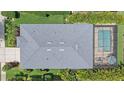 Aerial view of a single-Gathering home featuring a screened-in pool and well manicured lawn at 7338 Milestone Dr, Apollo Beach, FL 33572