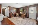 Charming living room featuring wood paneling, hardwood floors, and elegant furnishings at 806 Narcissus Ave, Clearwater Beach, FL 33767