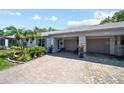 Well-maintained home featuring a two-car garage, colorful landscaping, and inviting curb appeal at 8244 Brentwood Rd, Seminole, FL 33777