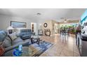 Cozy living room featuring tile flooring, comfortable seating, and ample natural light streaming in from adjacent rooms at 8244 Brentwood Rd, Seminole, FL 33777