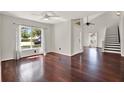 Bright living room with hardwood floors, large windows, and a staircase leading to the second floor at 9603 Sunnyoak Dr, Riverview, FL 33569