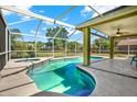 Inviting screened-in pool area featuring a swimming pool, hot tub, and covered patio with a ceiling fan at 9603 Sunnyoak Dr, Riverview, FL 33569