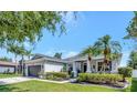 Inviting single-Gathering home featuring lush landscaping, a well-maintained lawn, and a convenient two-car garage at 10922 Holly Cone Dr, Riverview, FL 33569
