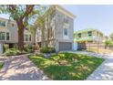 Charming townhouse with a well-kept lawn and inviting brick walkway to the entrance at 111 S Delaware Ave # 1, Tampa, FL 33606
