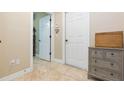 Bright hallway with tile flooring, multiple doors, and a charming side table at 111 S Delaware Ave # 1, Tampa, FL 33606