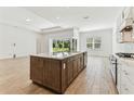 Open concept kitchen with a large island and stainless steel appliances at 11432 Shoreline Trl, Parrish, FL 34219