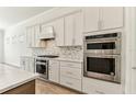 Gourmet kitchen showcasing stainless steel appliances and beautiful backsplash at 11432 Shoreline Trl, Parrish, FL 34219
