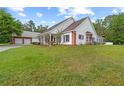Well-maintained home and detached garage with brick and white exteriors on a spacious, verdant lawn at 12345 Citrus Way, Brooksville, FL 34601