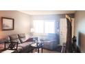 Comfortable living room showcasing a sofa, armchair, and bright natural light at 1235 S Highland Ave # 5-402, Clearwater, FL 33756