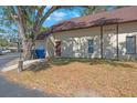 Well-lit exterior shot of a charming home with a brown roof and a neatly maintained front lawn at 12425 Touchton Dr # 77, Tampa, FL 33617