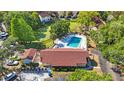 Aerial view of community pool with turquoise water, clubhouse and tennis courts at 12425 Touchton Dr # 77, Tampa, FL 33617